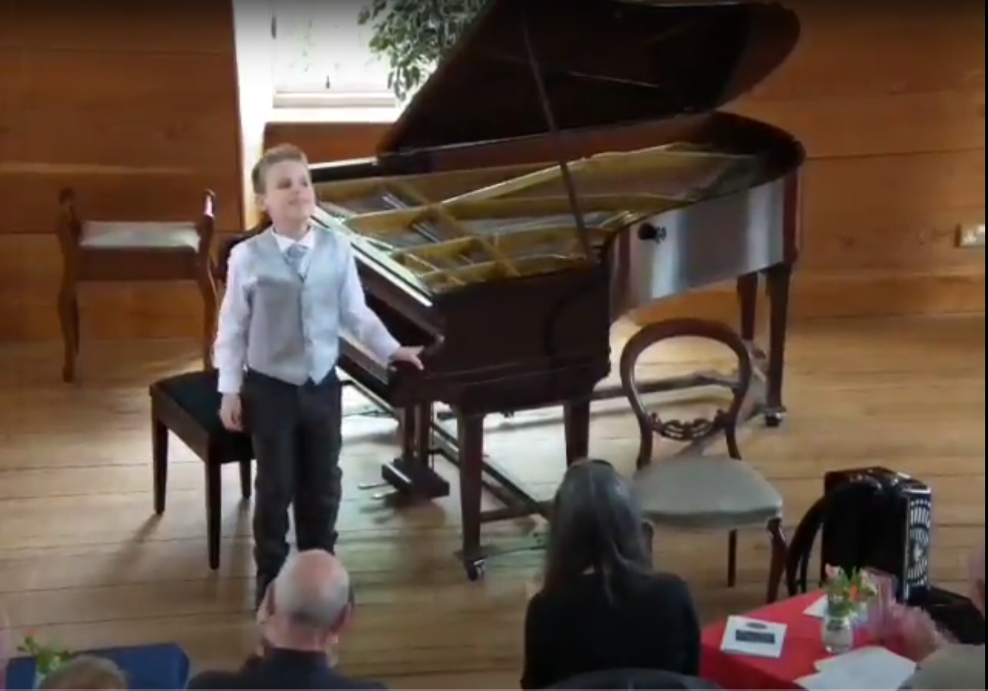 Ethan standing at a grand piano