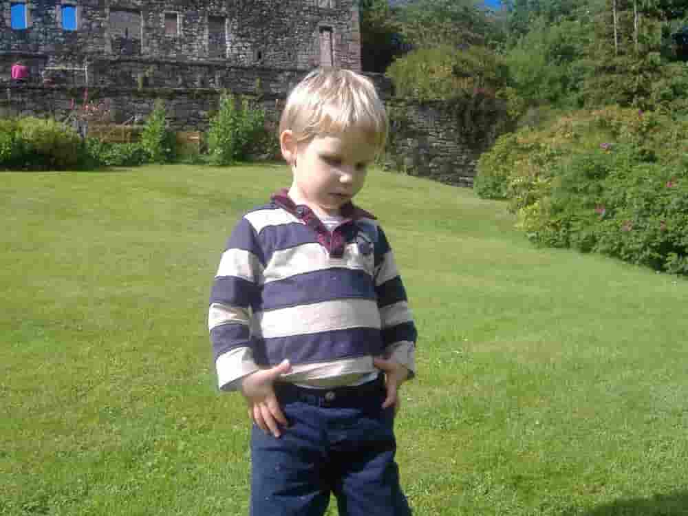 Ethan Age 3 Standing In Front of Dollar Castle